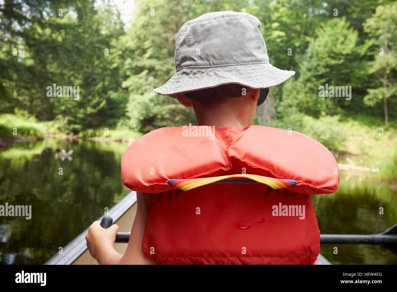Young boy in canoe, rear view Stock Photo - Alamy