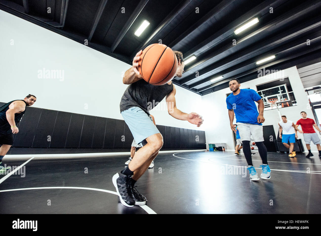 Male basketball player running with ball on basketball court Stock Photo Alamy