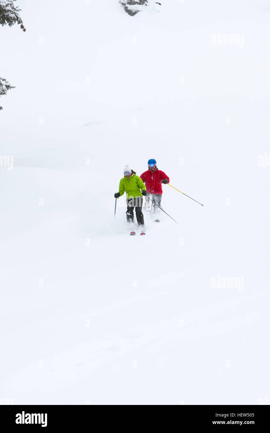 Two skiers, skiing downhill, low angle view Stock Photo