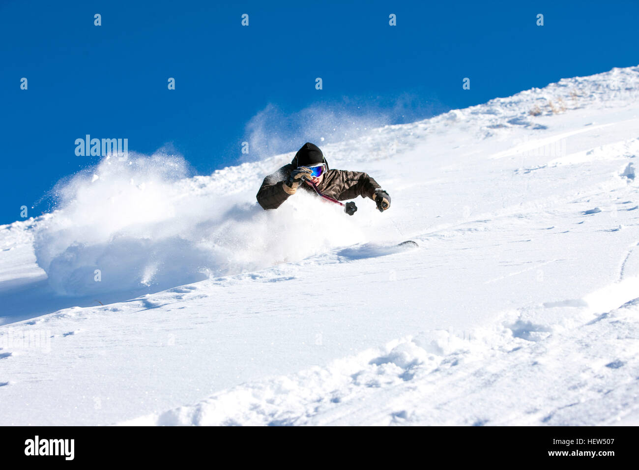 Skier, skiing downhill, low angle view Stock Photo