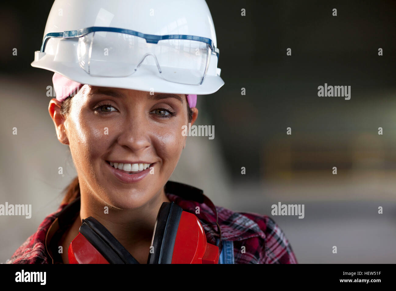 Portrait of young female worker in hard hat Stock Photo