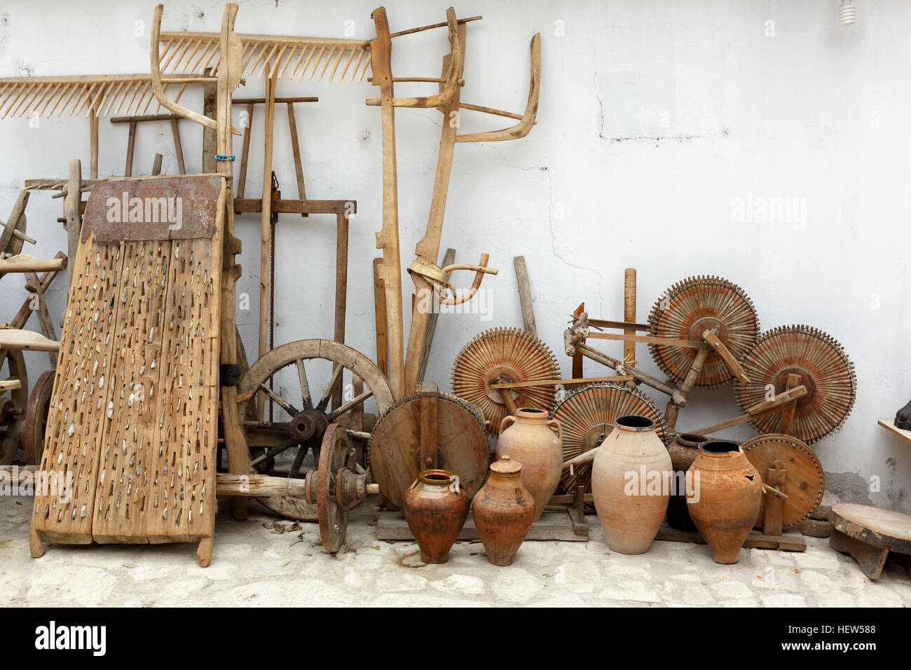 Background with a group of old and unused wooden wheels of carts and old fashioned yarn producing machinery equipments Stock Photo
