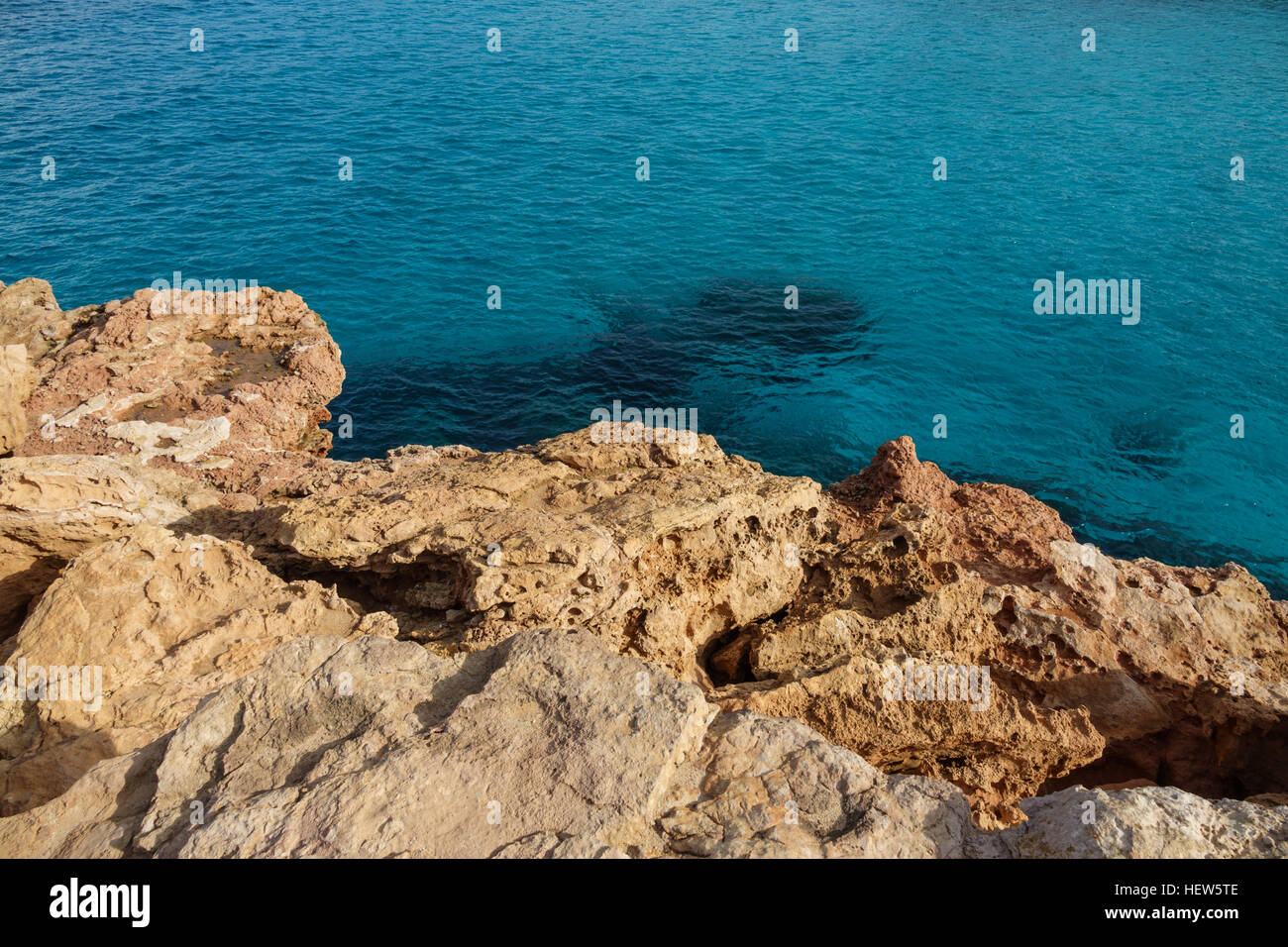 Clear Sea Rocks Clear sea water and rocks in the coast Stock Photo - Alamy