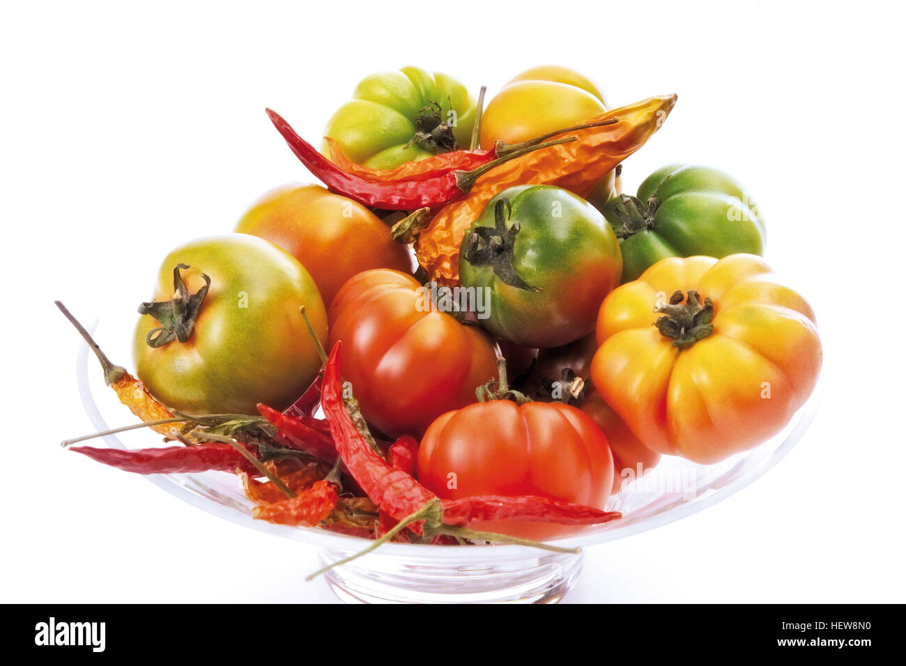 Assorted tomato types and red hot chili peppers in a glass bowl Stock ...