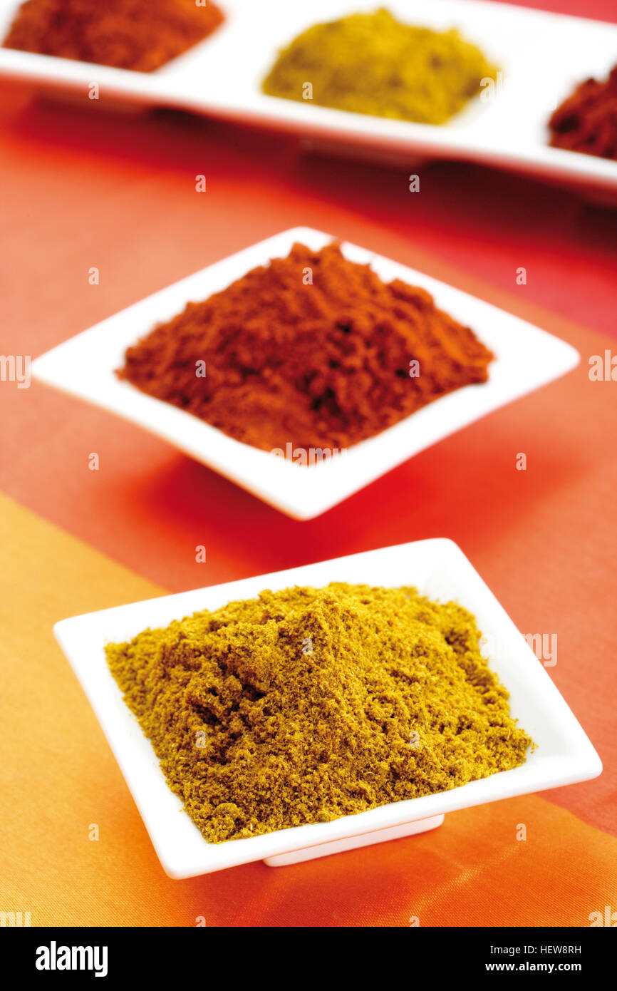 Paprika powder and curry powder in porcelain dishes Stock Photo Alamy