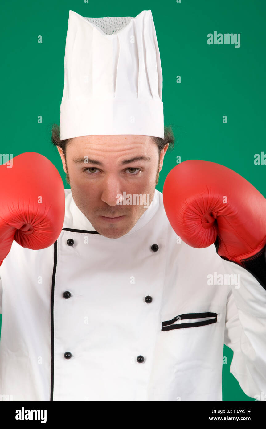 Chef wearing boxing gloves, fists raised Stock Photo - Alamy