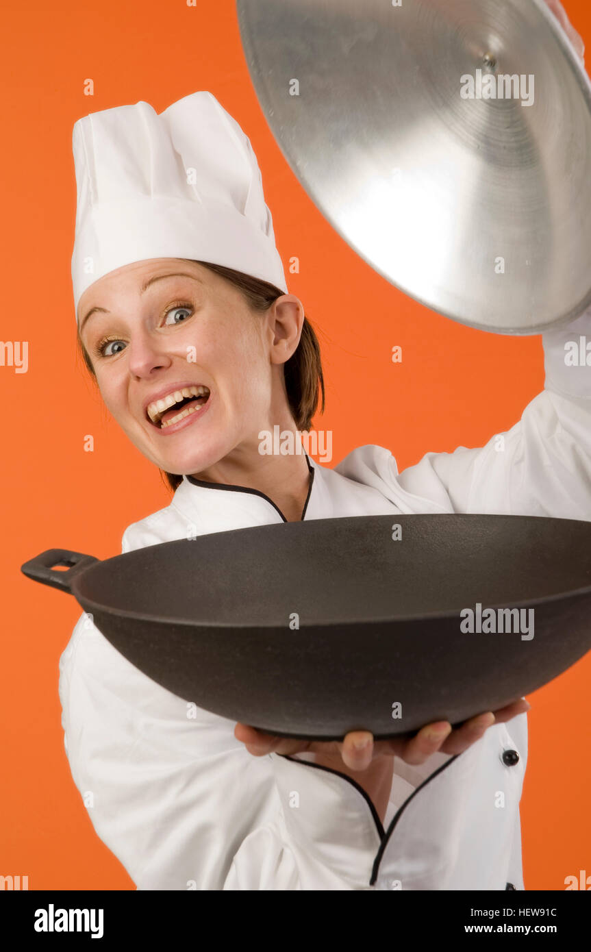 https://c8.alamy.com/comp/HEW91C/young-female-chef-holding-a-wok-pan-HEW91C.jpg