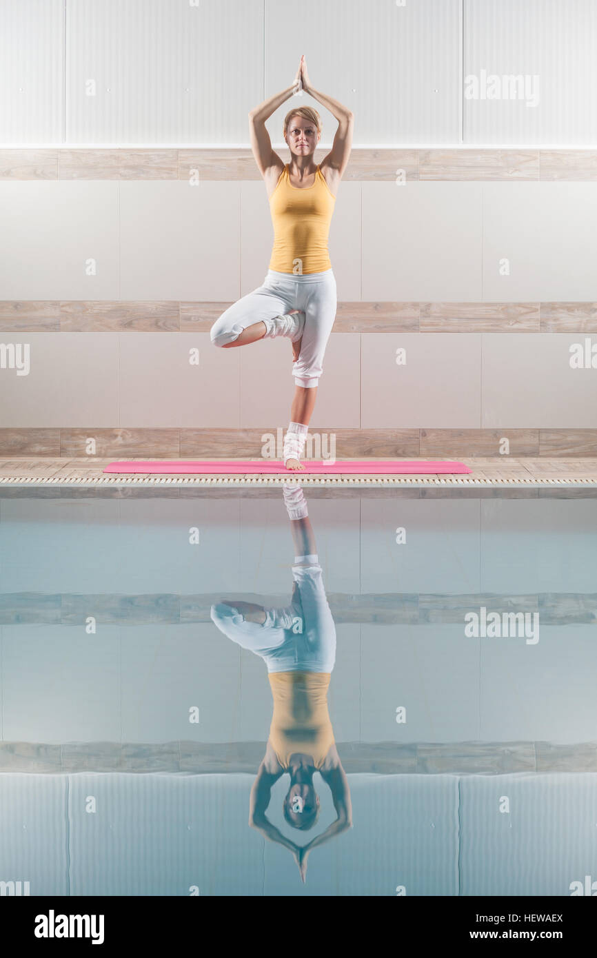 Young woman is practicing yoga Stock Photo - Alamy