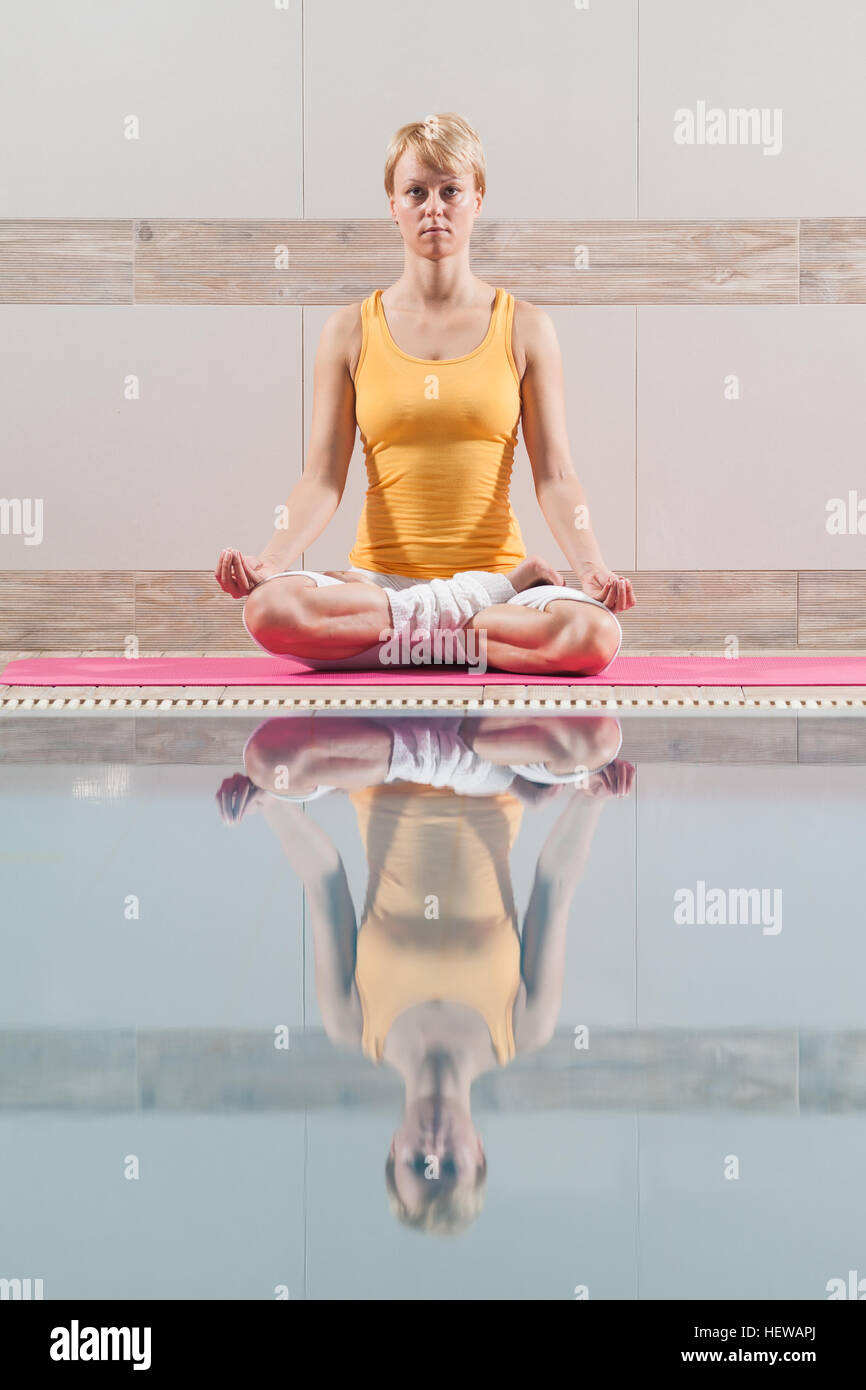 Young woman is practicing yoga Stock Photo - Alamy