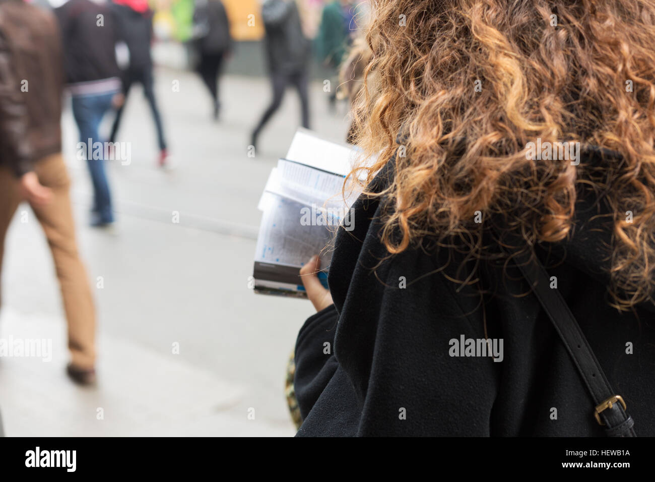 Young women tourists looks for a place from travel guide book in istiklal street,Istanbul Stock Photo