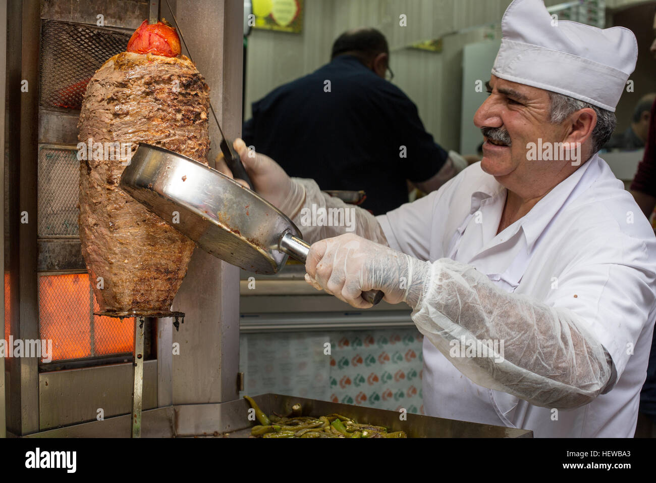 cook slice doner kebap to serve customers around Eminonu district ,Istanbul Stock Photo
