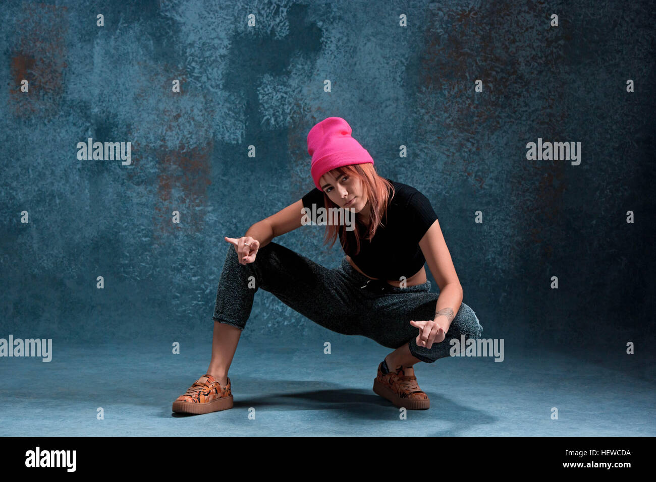 Young girl break dancing on blue studio background Stock Photo Alamy