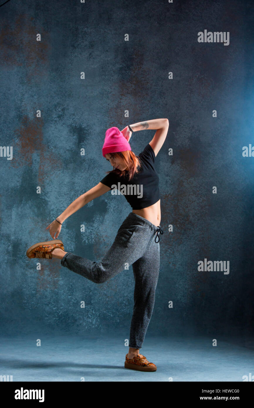 Young girl break dancing on blue studio background Stock Photo Alamy