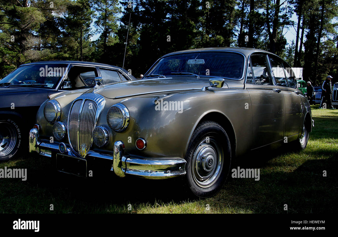 The Daimler 2.5 V8 (or 2½-litre V8) was a four-door saloon produced in Coventry, England by Daimler. Launched late in 1962.[2] Essentially a rebadged Jaguar Mark 2 fitted with Daimler's particularly smooth 2.5-litre V8 engine and drive-train, a special Daimler fluted (furrowed brow) grille and rear number plate surround, distinctive wheel trims, badges, and interior details (such as a split-bench front seat and a black enamel steering wheel) and special interior and exterior colours with its soft V8 burble a casual observer, though not its driver, might mistake it for a Jaguar Mark 2. Most car Stock Photo