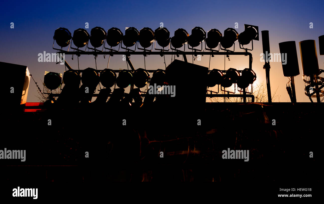 Background of silhouette of concert stage with blue sky and sun light ...