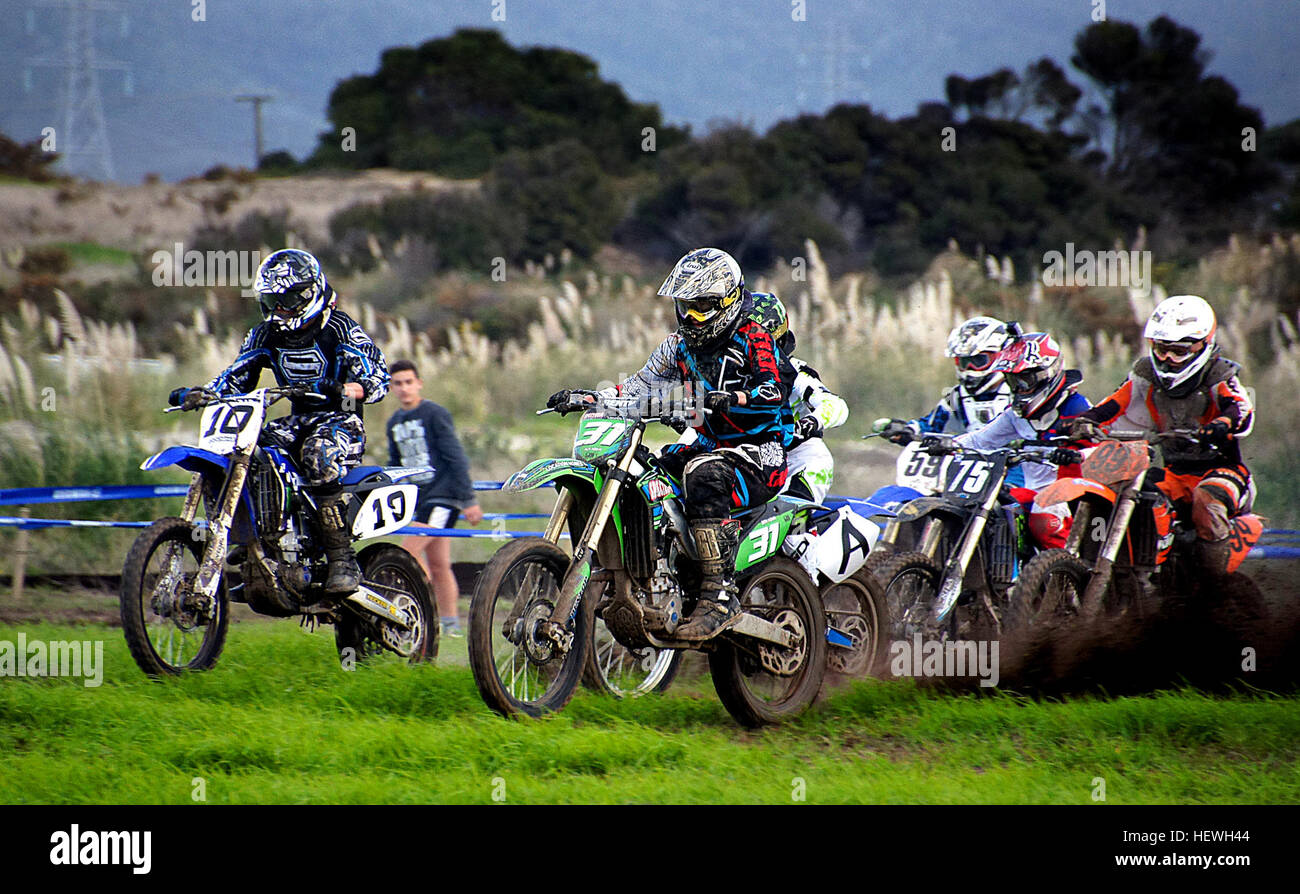 Safety in motocross has evolved through the years. In its infancy, motocross protective gear was a pair of gloves, a jacket, leather pants, a set of goggles, and a helmet that was open-faced. When crashes occurred, they were usually fatal. Today, FIM inspects any and every track bidding to hold high-stakes races so as to ensure that long-established safety guidelines are met. Protective gear runs head to toe, and includes full-face helmets, padding in strategic places, jackets made of highly-durable kangaroo leather, and reinforced boots and gloves that allow for movement, just not in the wron Stock Photo