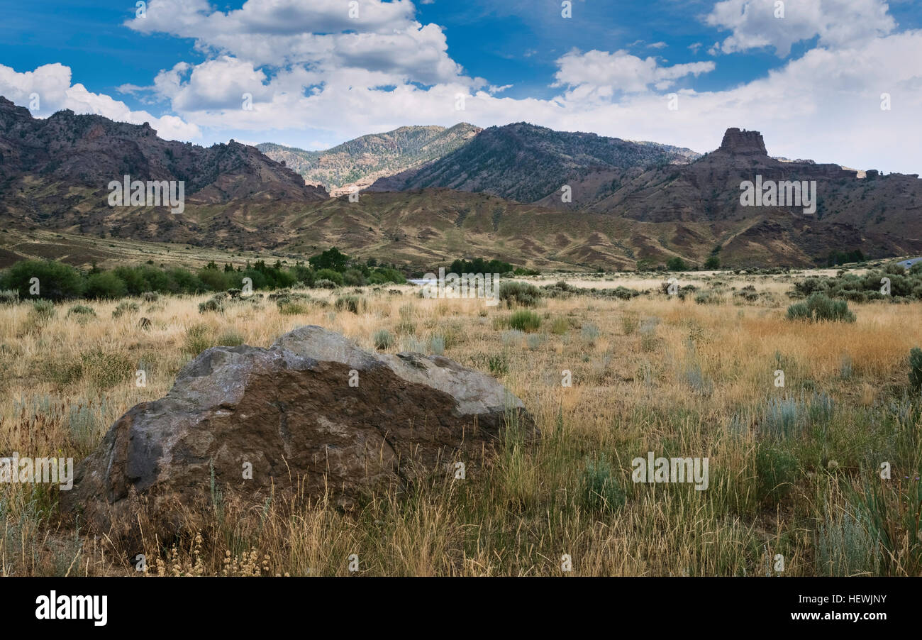The Rocky Mountains and the arid landscape of Buffalo Bill National Park with a glimpse of the Shoshone river near Cody, Wyoming Stock Photo