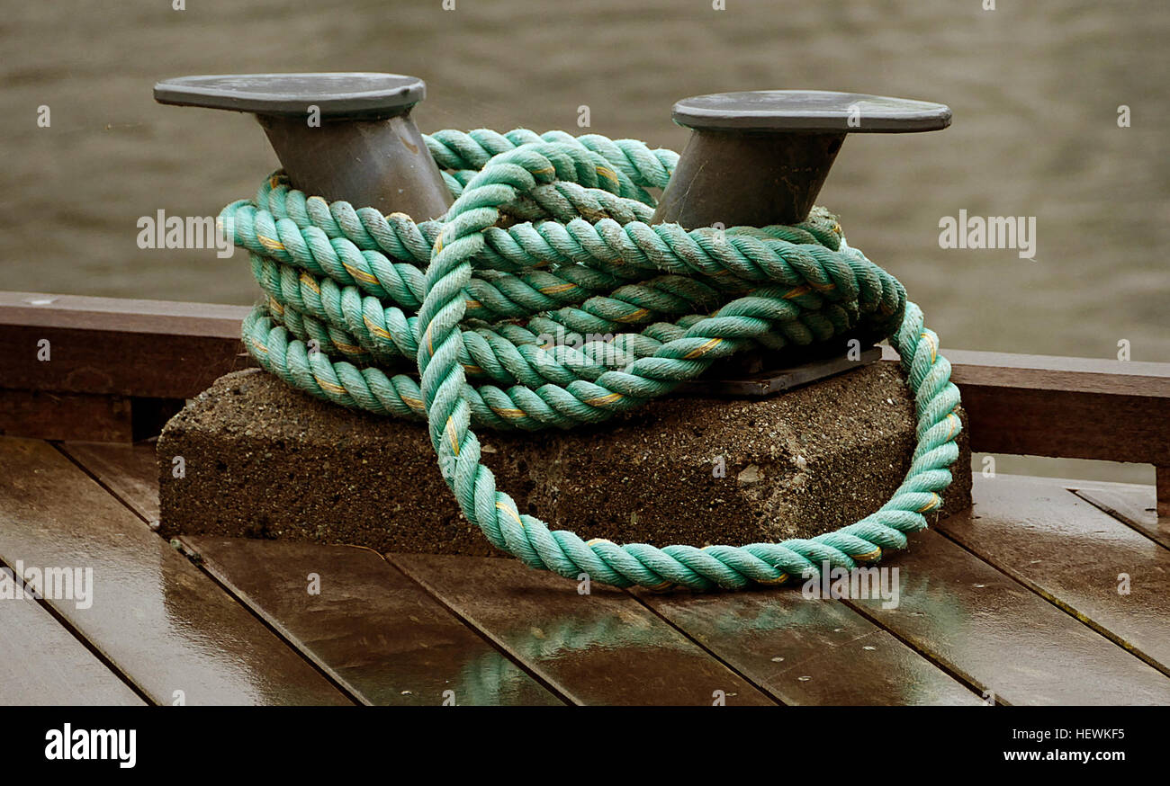 Docking Rope Principle This photograph captures the moment a mooring rope is secured to a ...