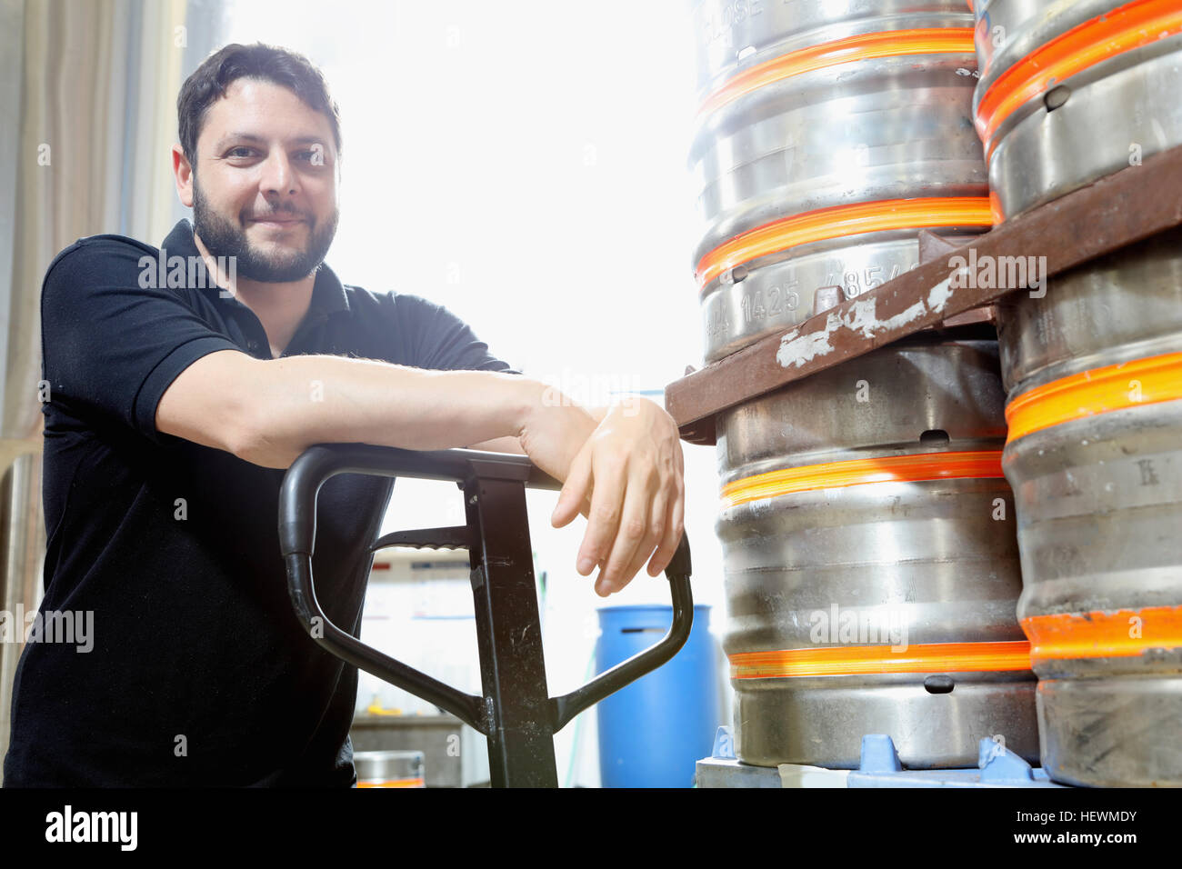 Portrait of worker in brewery organising beer barrels for delivery Stock Photo