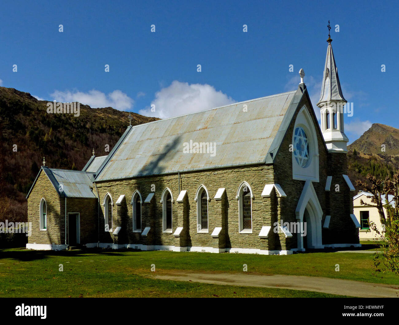 St. Patricks Catholic Church was built in three phases, the main body of the church in 1874, the sanctuary in 1882, and the sacristy in 1902. The stone church is in a Gothic Revival style. The church is included in the St. Joseph Parish in Queenstown.  In the 1897, Mary Helen MacKillop, an Australian nun and founder of the Sisters of St Joseph of the Sacred Heart, visit Arrowtown to help the church with their school. Mary Helen MacKillop, was canonized in 2010 as Saint Mary of the Cross, the first Australian saint.  The church continues as an active church with Mass celebrated on the 1st, 3rd  Stock Photo