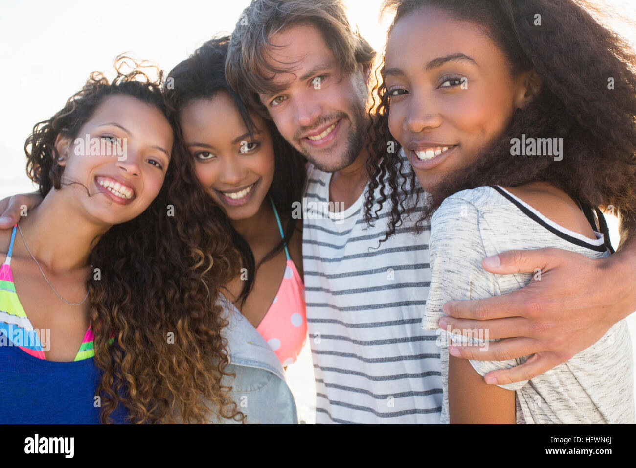 Portrait of young man and three female best friends on beach, Cape Town, South Africa Stock Photo