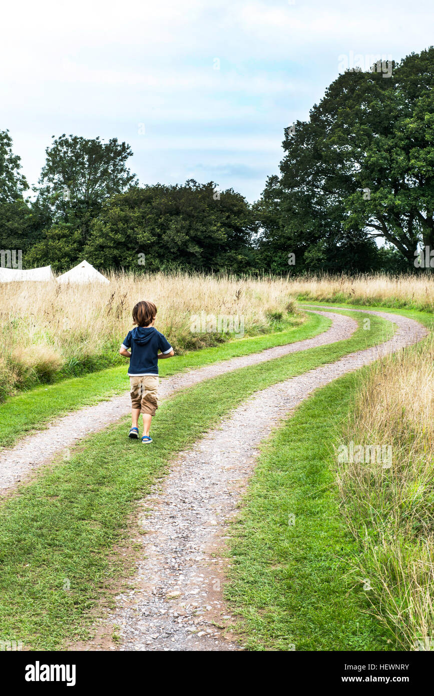Boy walking on dirt track hi-res stock photography and images - Alamy