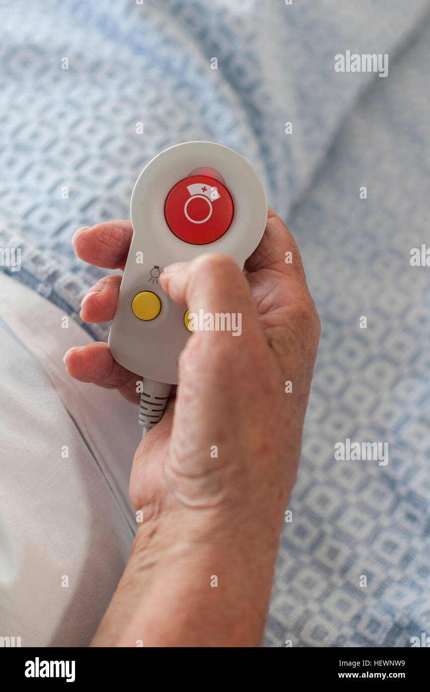 Cropped view of patient's hand holding call button Stock Photo
