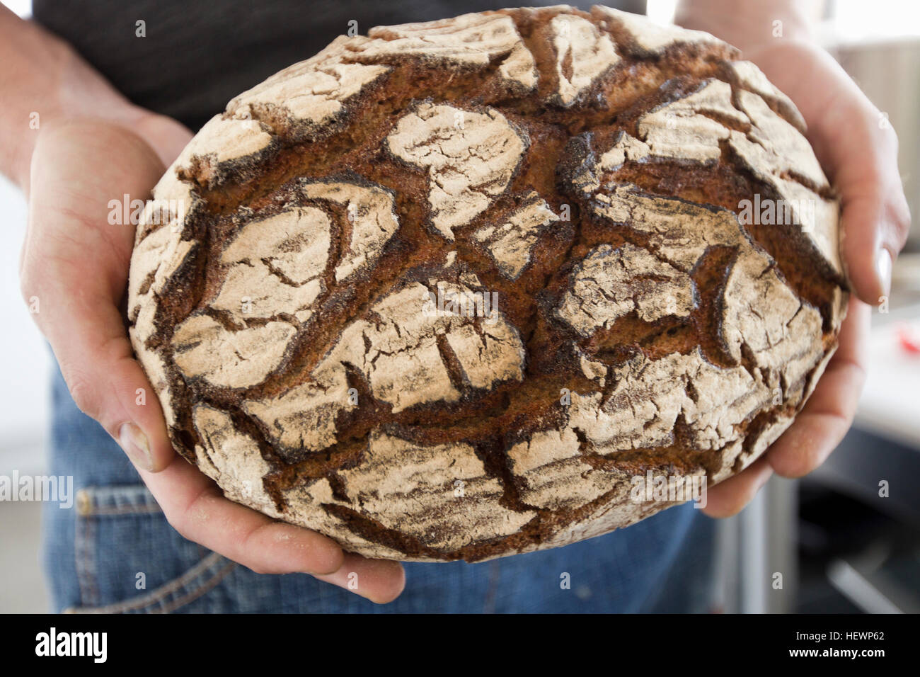 Cropped view of man holding freshly baked bread Stock Photo