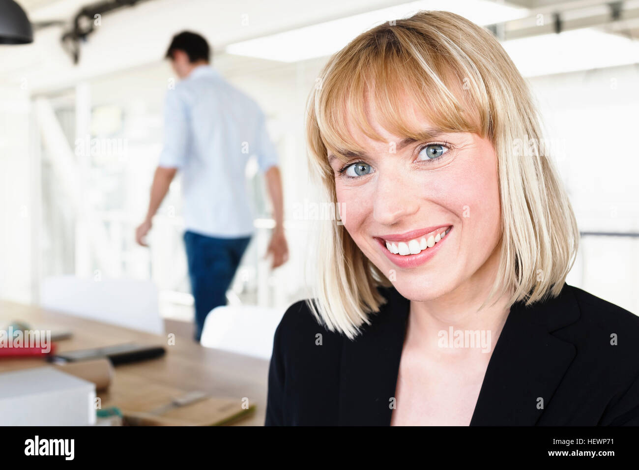 Portrait of business woman looking at camera smiling Stock Photo