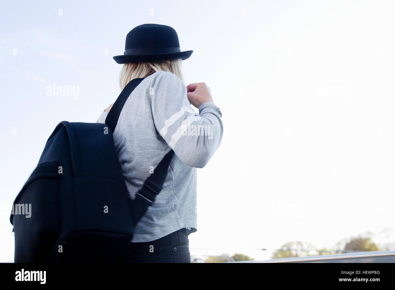 Rear view of woman wearing hat carrying backpack Stock Photo