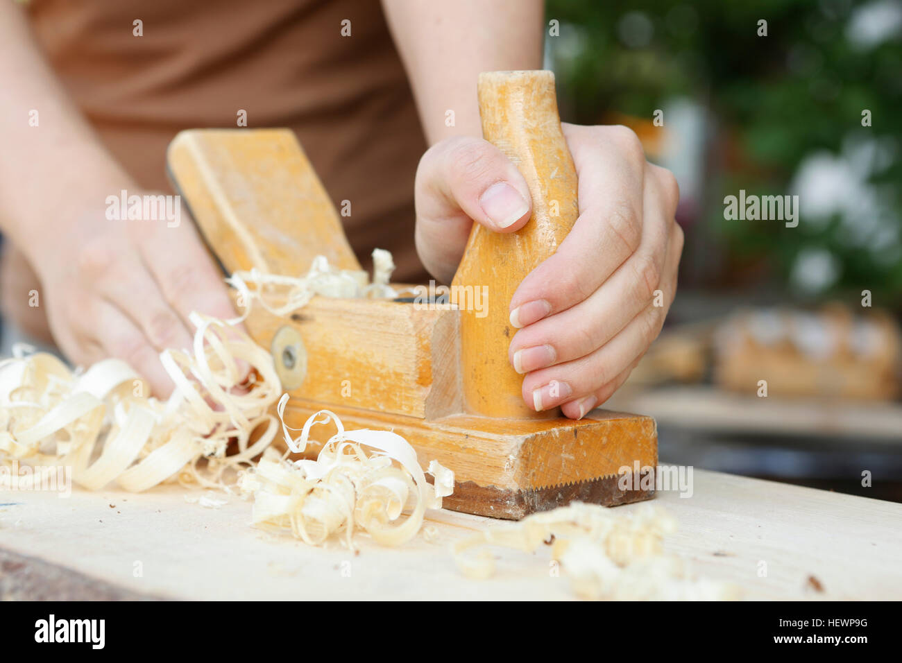 Cropped view of woman using wood plane Stock Photo