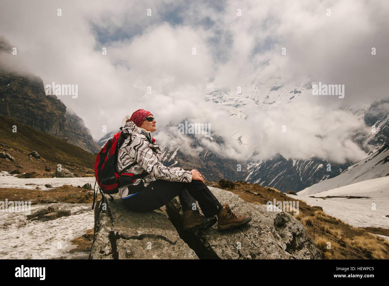 Woman, sitting, looking at view,  ABC trek (Annapurna Base Camp trek), Nepal Stock Photo