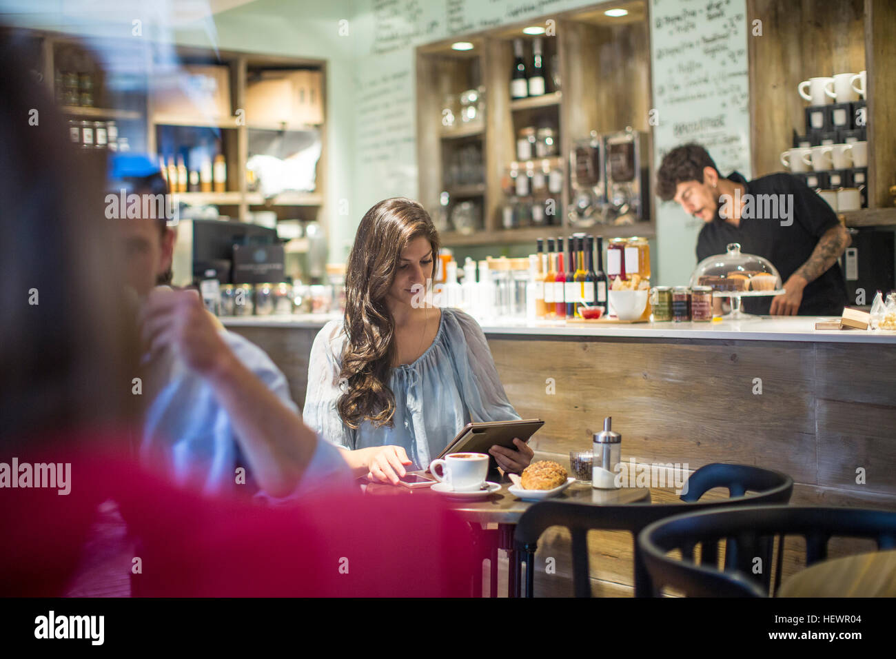 Young woman looking at digital tablet in cafe Stock Photo