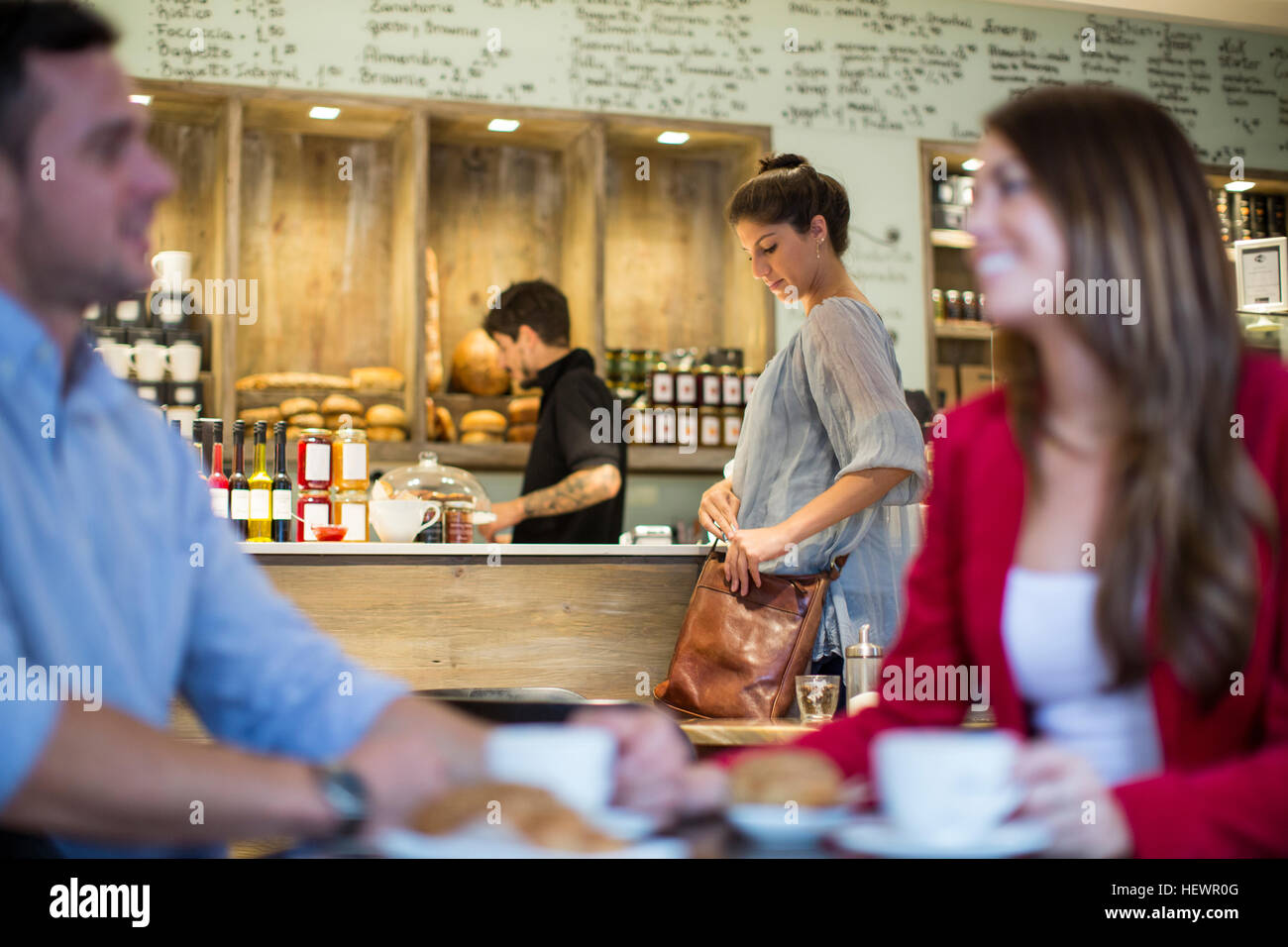 Couple talking in busy cafe Stock Photo