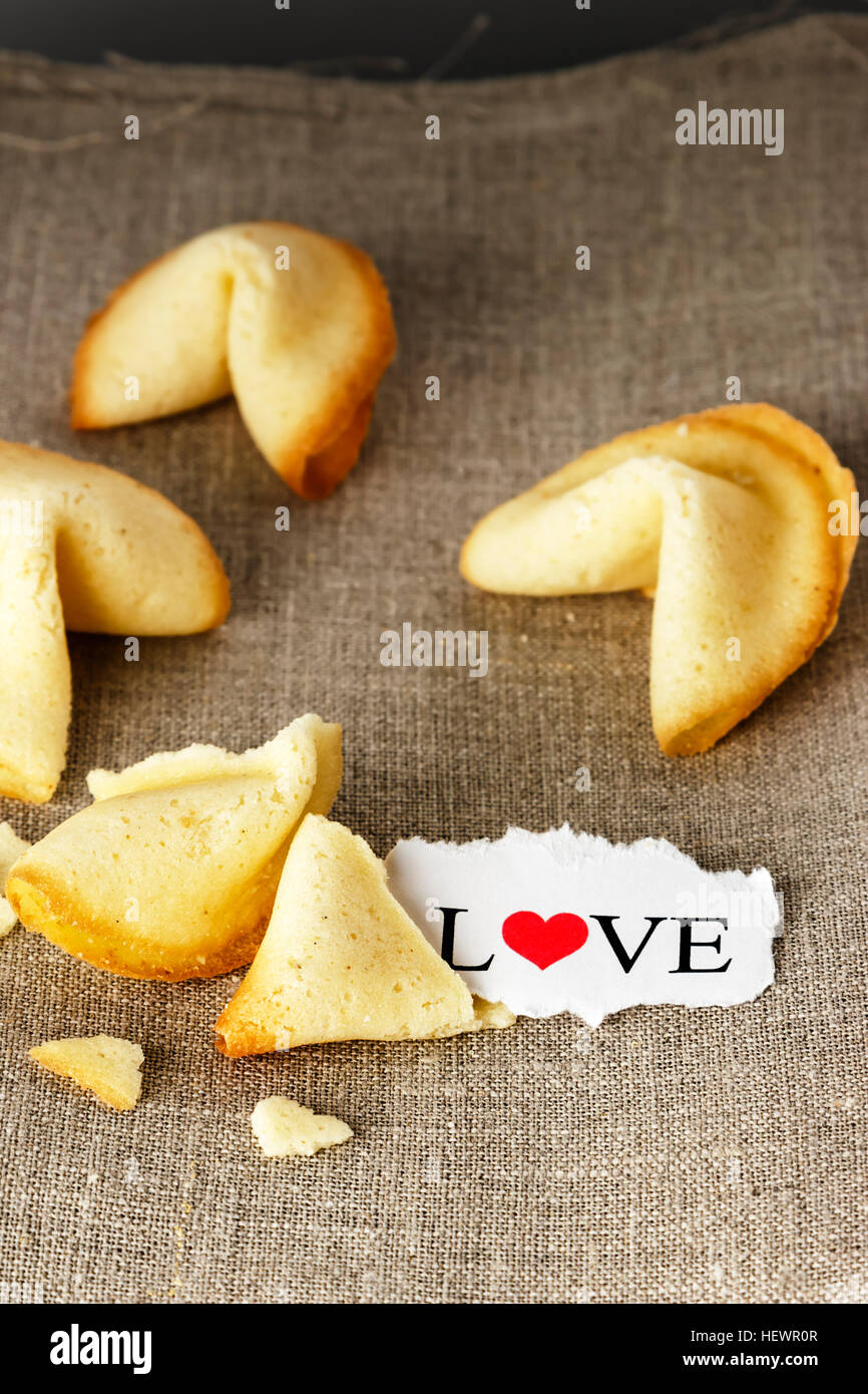 Cookies shaped like tortellini with the word love written on a paper.Vertical image. Stock Photo