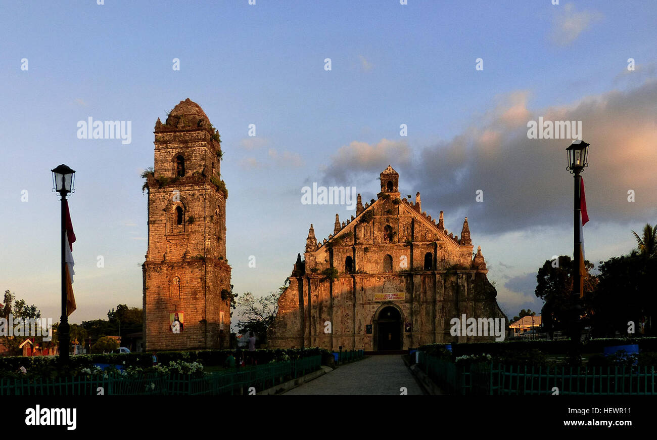 The Paoay Church (also known as the St. Augustine Church ) is a historical church located in the town of Paoay in Ilocos Norte, Philippines. Construction of the Paoay Church was started by the Augustinian friars in 1694. It was completed in 1894 led by Fr. Antonio Estavillo and was re-dedicated in 1894. A three-storey coral stone bell tower stands to the right of the church which served as an observation post in 1896 for the Katipuneros during the Philippine revolution against the Spaniards, and again by the Filipino guerillas during the Japanese occupation in World War II. The Church is a uni Stock Photo