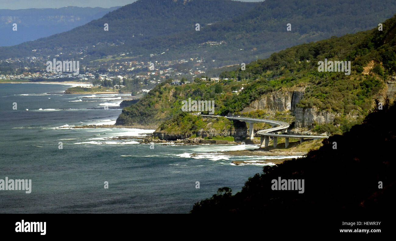 The Sea Cliff Bridge is a balanced cantilever bridge located in the northern Illawarra region of New South Wales, Australia. The $52 million bridge links the coastal villages of Coalcliff and Clifton. Featuring two lanes of traffic, a cycleway and a walkway, the Sea Cliff Bridge boasts spectacular views and is a feature of the scenic Lawrence Hargrave Drive.  The Sea Cliff Bridge replaced a section of Lawrence Hargrave Drive that was permanently closed in August 2003 due to regular rock falls. A public outcry emerged over the road closure as Lawrence Hargrave Drive is the only road directly li Stock Photo
