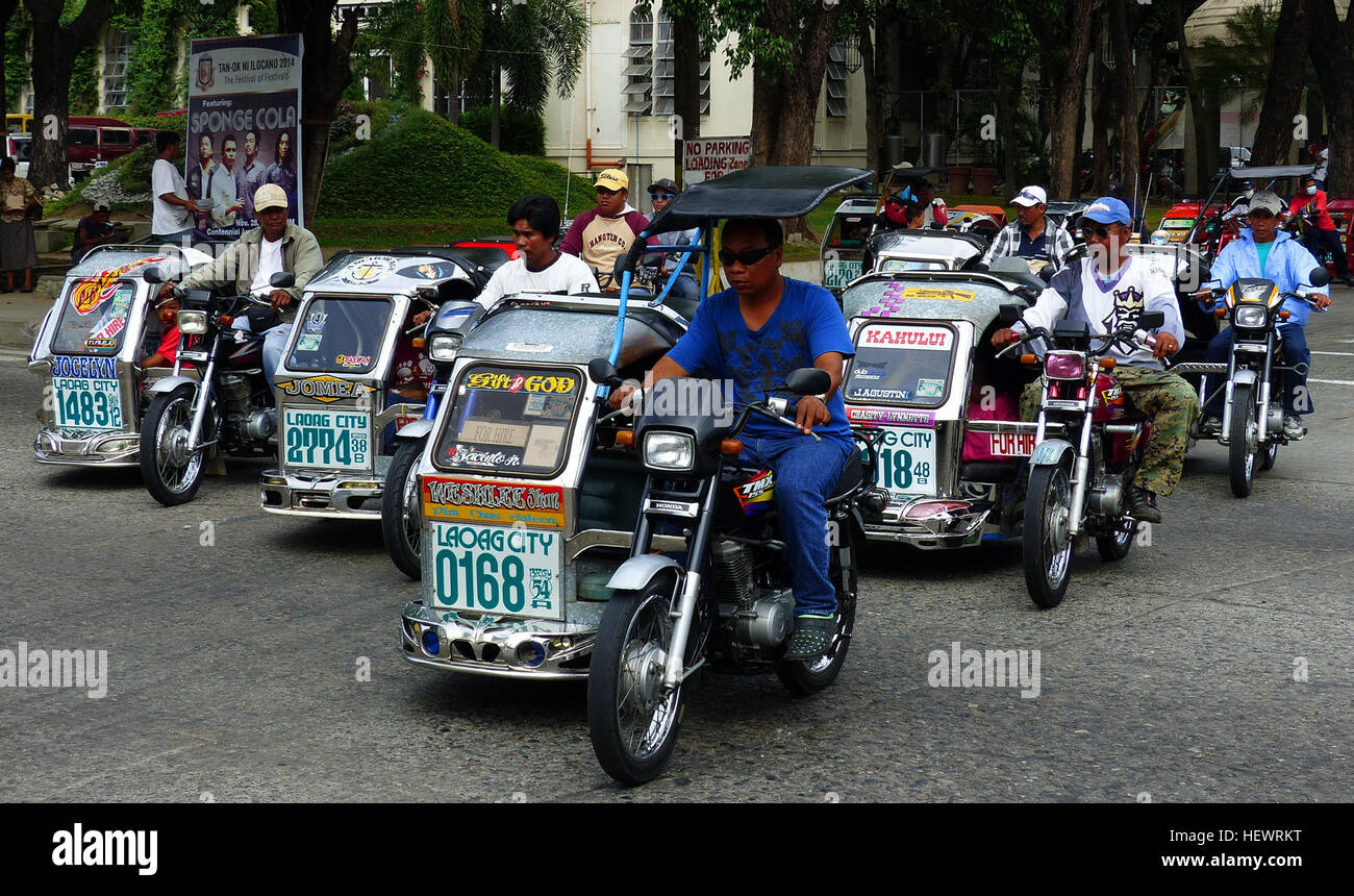 A Philippine pedicab is called a traysikad, trisikad--or simply sikad--or padyak, from the Philippine word meaning to tramp or stamp one's feet. It is made by mounting a sidecar to a regular bicycle. They are used mainly to ferry passengers short distances along smaller, more residential streets, often to or from jeepneys or other public utility vehicles. They are also used for transporting cargo too heavy to carry by hand and over a distance too short or roads too congested for motor transport, such as a live pig. During rainy seasons, they are useful as a way to avoid walking through flood w Stock Photo