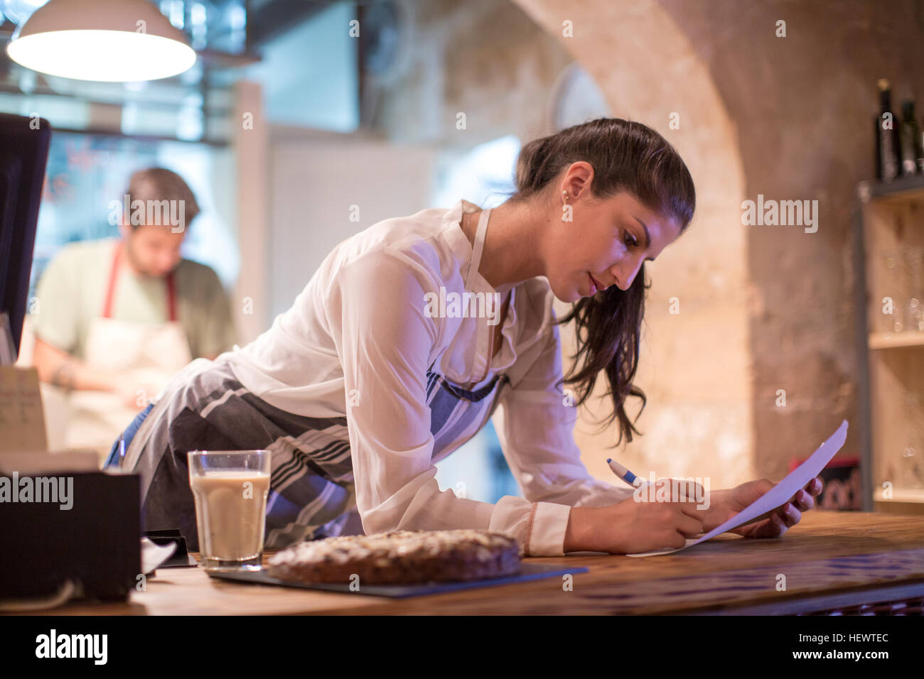 Restaurant owners working in kitchen Stock Photo Alamy