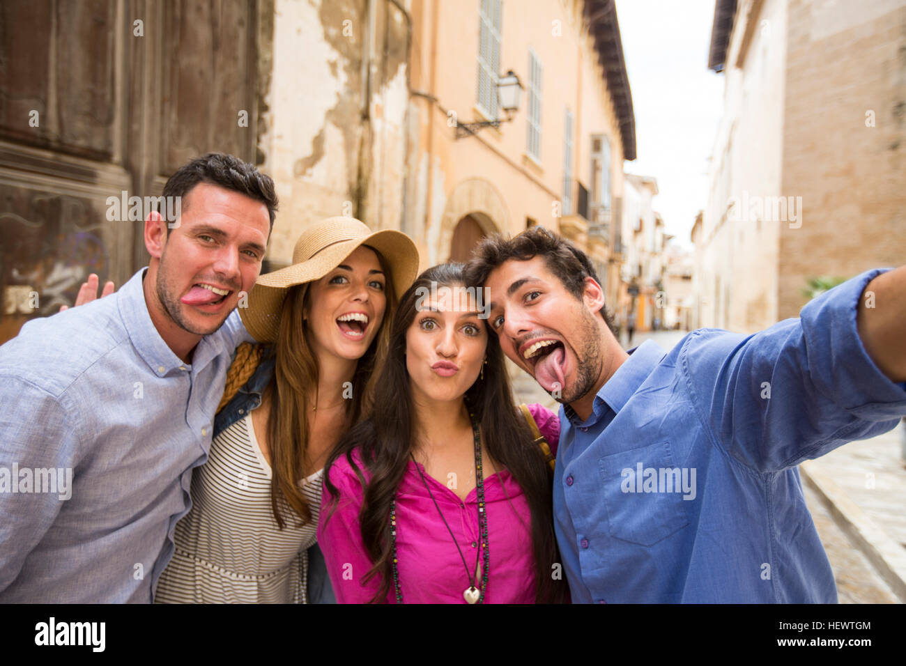 Couples making faces and taking selfie on street, Palma de Mallorca, Spain Stock Photo