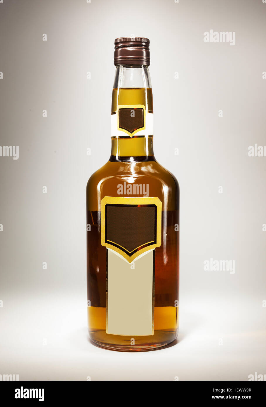 Just a bottle of a spirit drink on white background, with empty label. Stock Photo