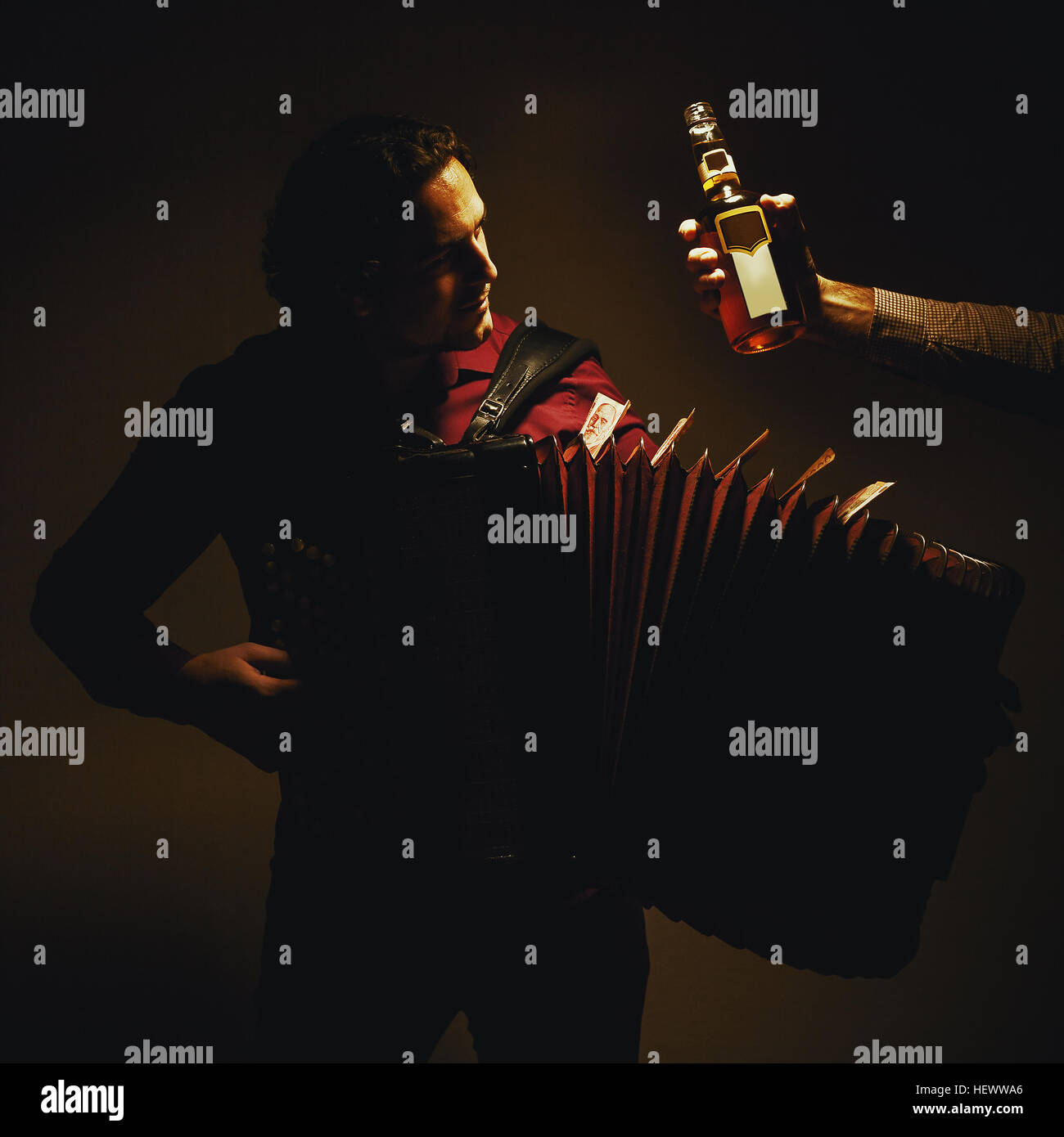 Modern accordion player posing with his chromatic harmonica type