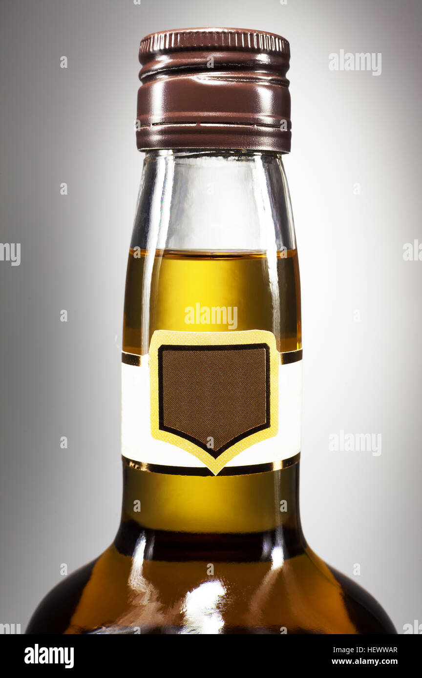 Just a top of a bottle of a spirit drink on white background, with empty label. Stock Photo