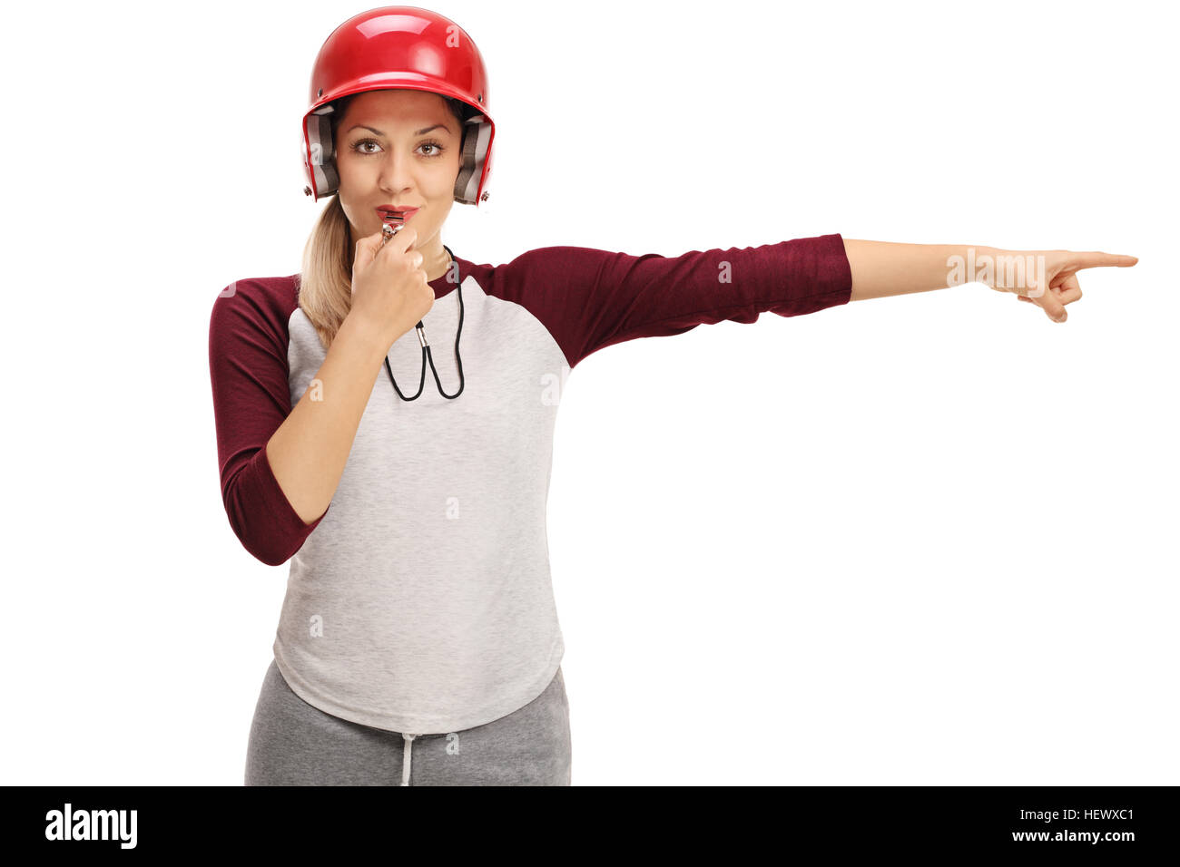 Female baseball coach blowing a whistle and pointing right isolated on
