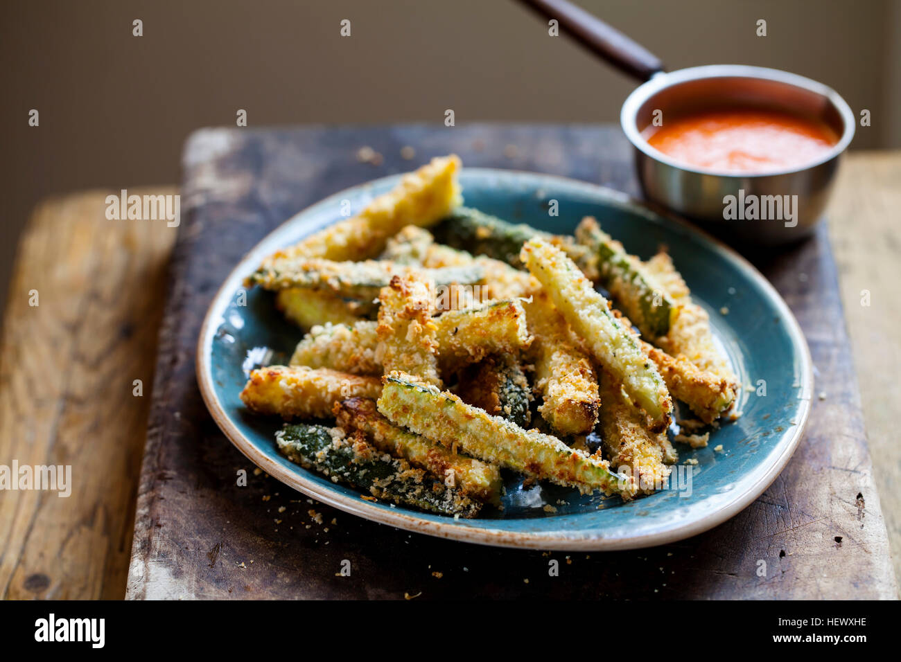 Zucchini fires with roast pepper and tomato sauce Stock Photo