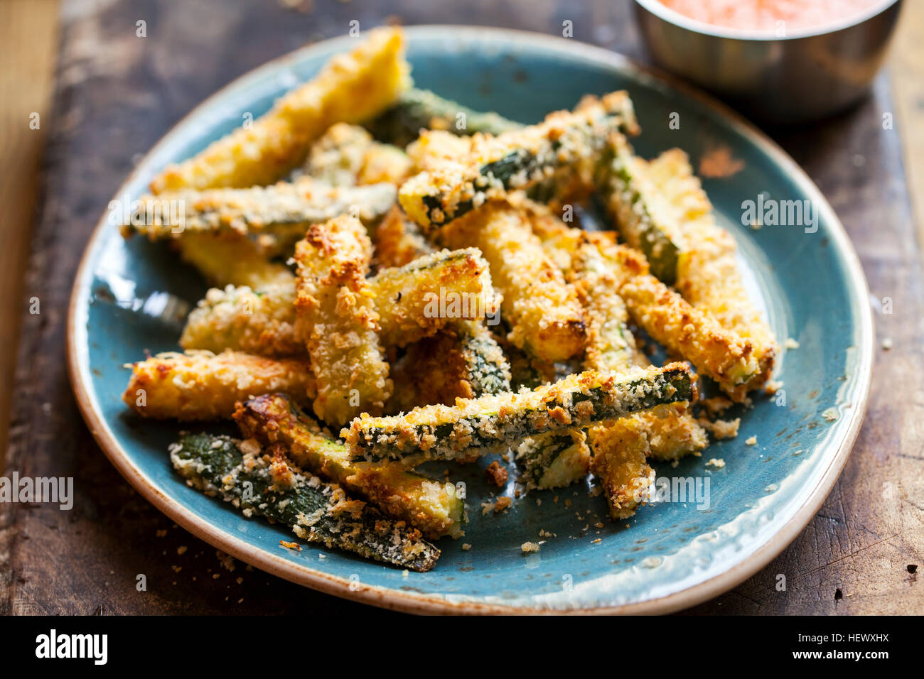 Zucchini fires with roast pepper and tomato sauce Stock Photo