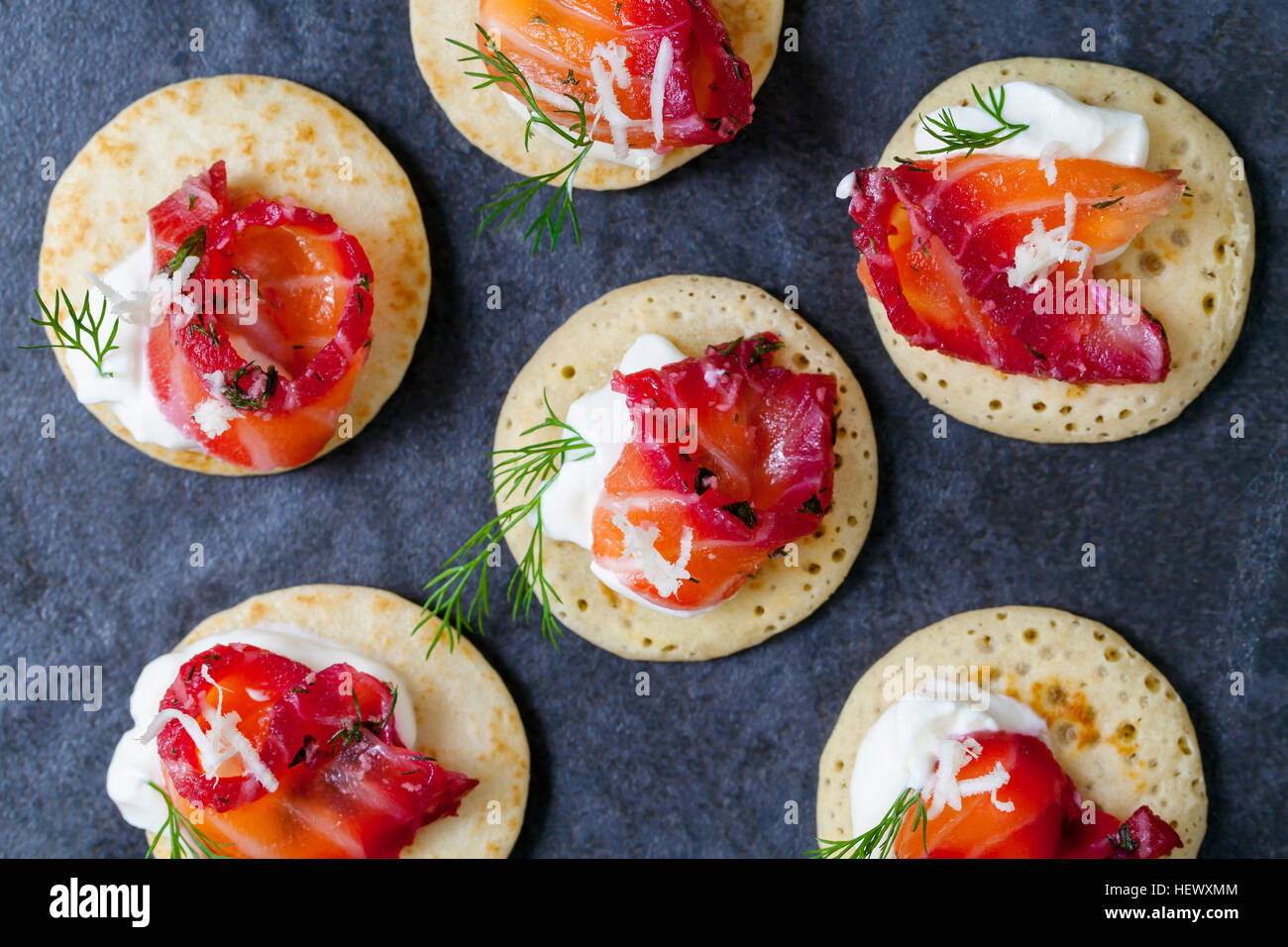 Party blinis with beetroot cured salmon, cream and horseradish Stock