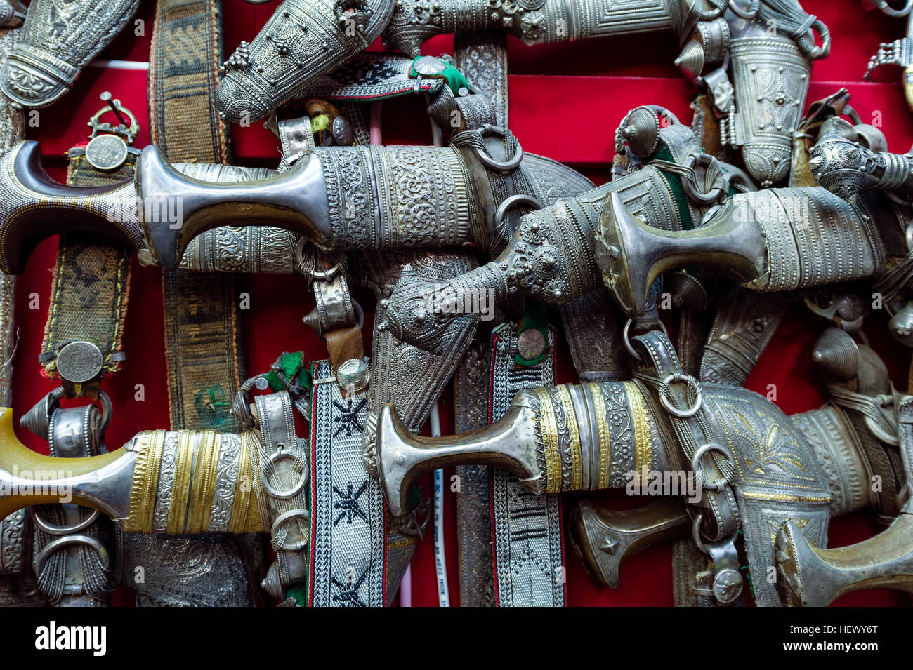 A wall displaying silver khanjar knives for sale in a souq. Stock Photo