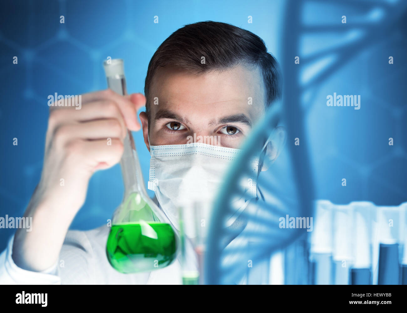 Young scientist mixing reagents in glass flask in clinical laboratory