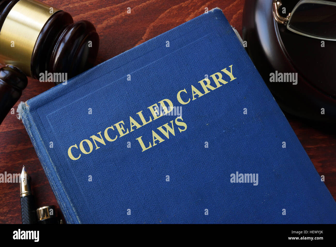 Concealed Carry Laws title on a book and gavel. Stock Photo
